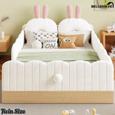 Front view of white twin upholstered bed with bunny pillows and wood-look base