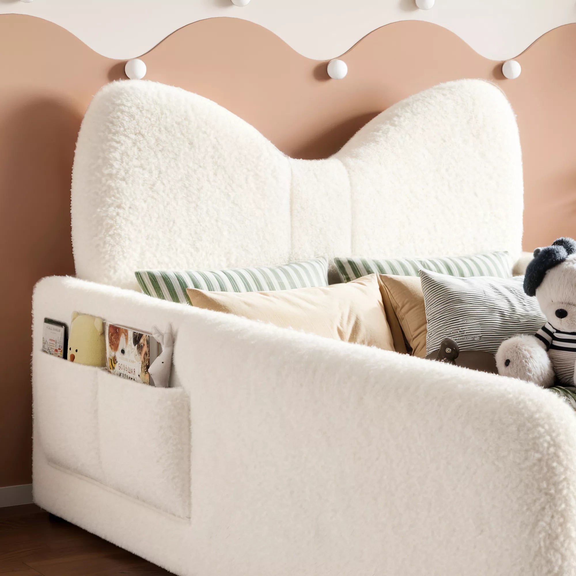 kids upholstered platform bed with bow shaped headboard and side storage pockets