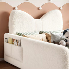 kids upholstered platform bed with bow shaped headboard and side storage pockets