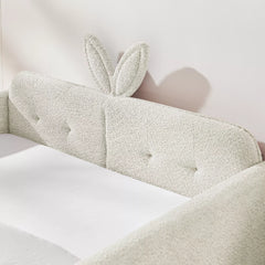 Cute 3D bunny ear tufted headboard close‑up, boucle upholstered full size kids bed headboard detail, cream white