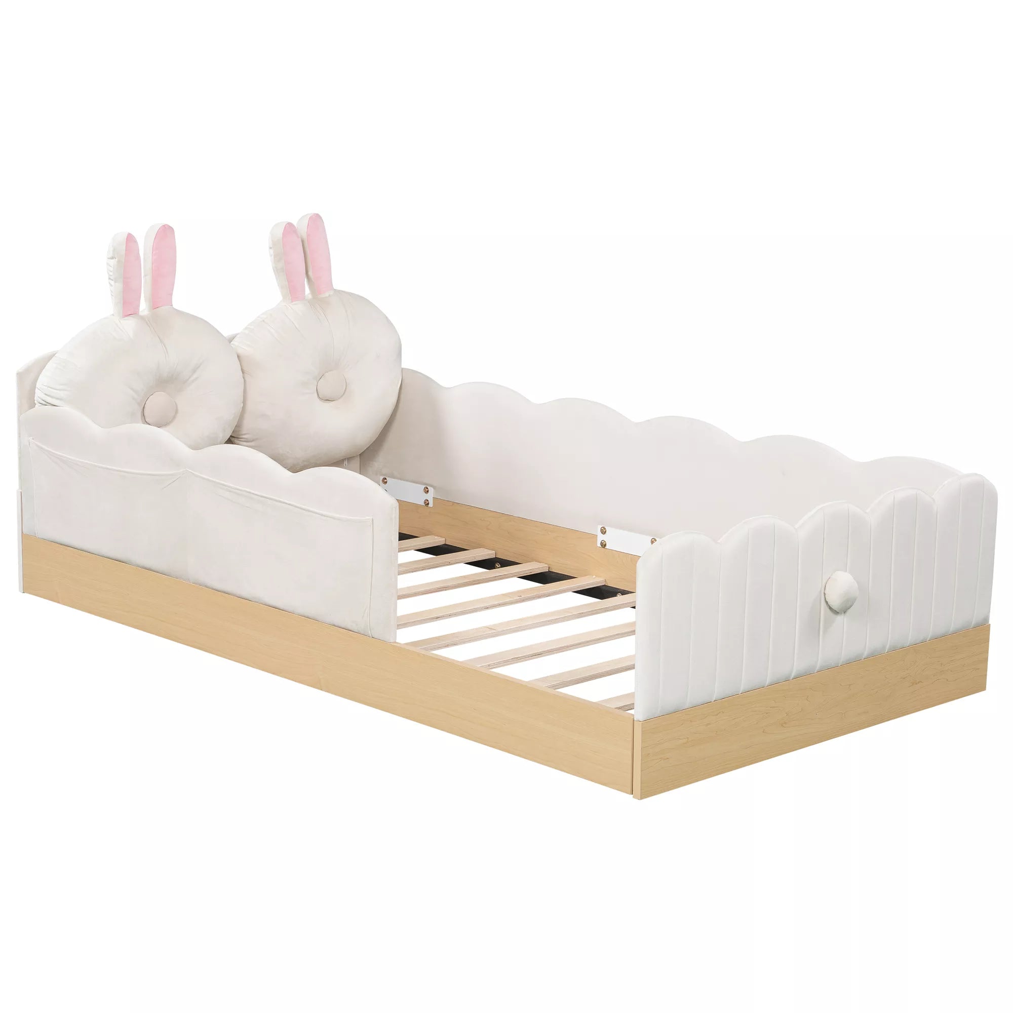 Side view of white upholstered platform bed with bunny pillows and wood-look base