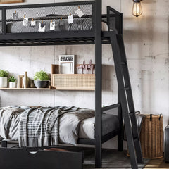 Lifestyle view of a black metal bunk bed with an angled ladder and mesh upper guardrails