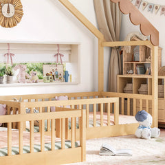 Side view of the house-shaped floor bed showing wooden guardrails and low sleeping areas
