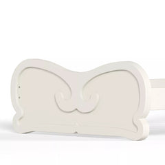 Decorative Carved Footboard Detail of White Platform Bed