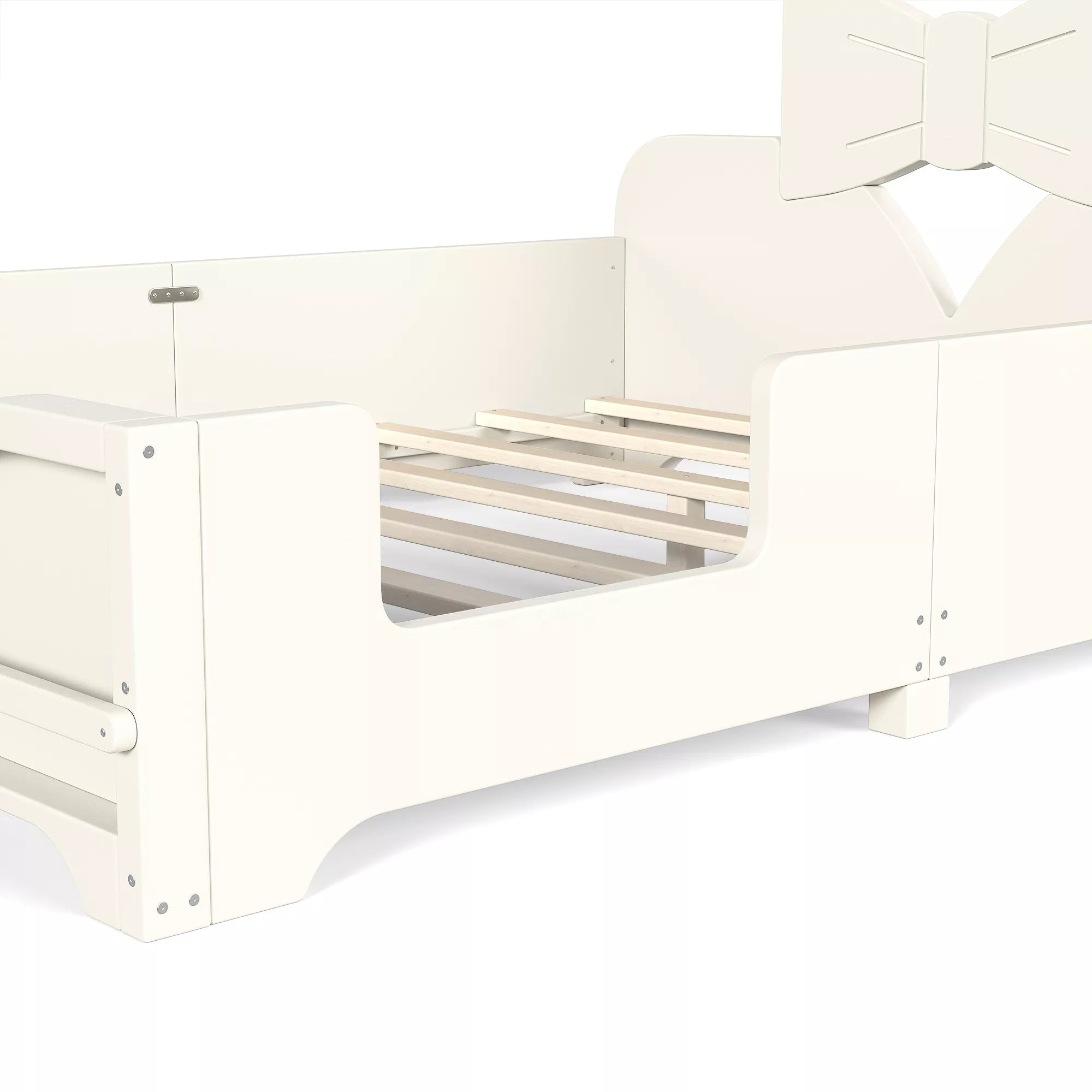 Close‑up view of white kids bed frame showing wooden slats, safety side rails and bow headboard structure