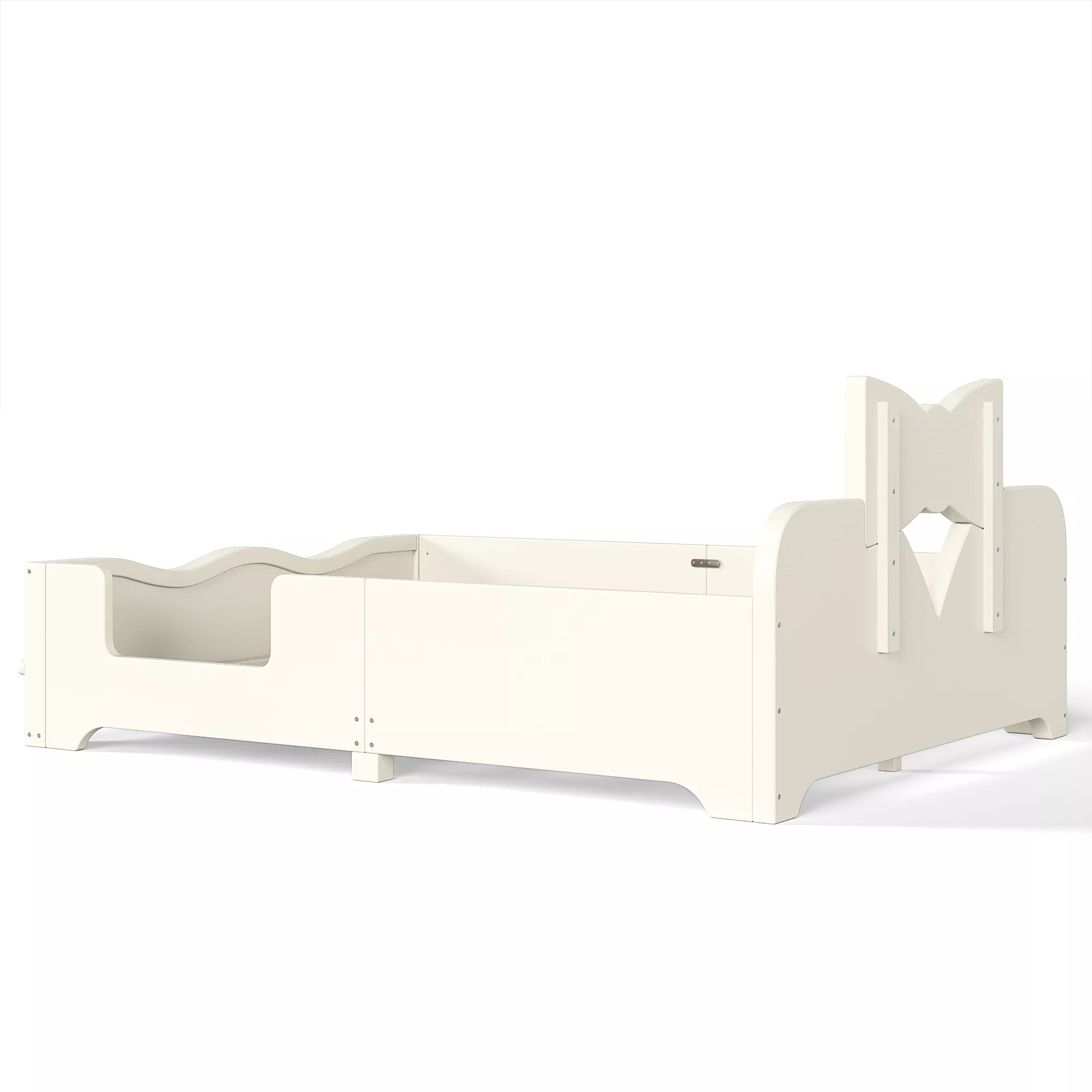 Rear side view white wooden children bed frame with bow shaped headboard and surrounding safety rails
