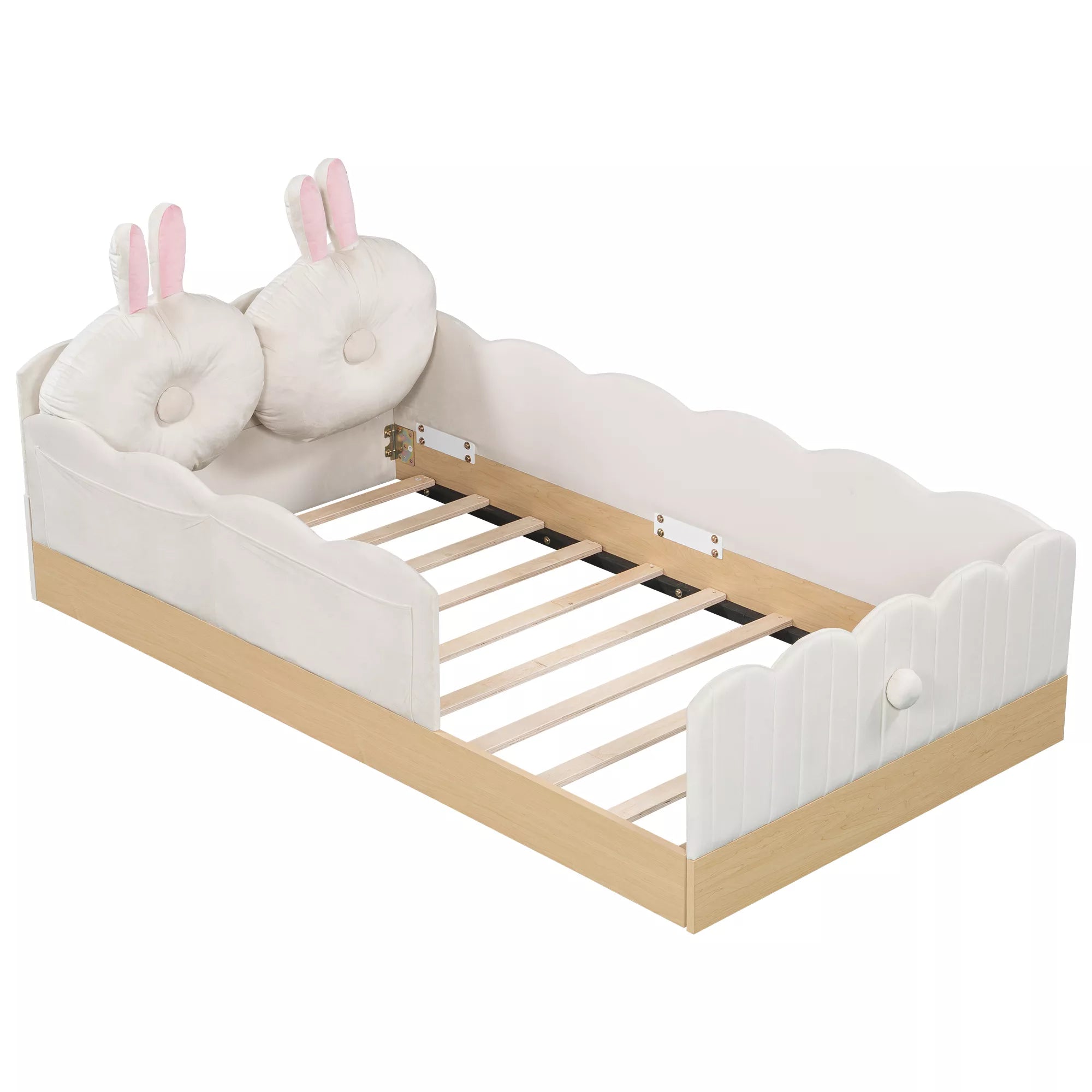 Angled view of white upholstered platform bed with bunny pillows and wooden slats