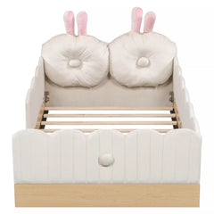 Front view of white twin upholstered bed with bunny pillows and scalloped panels