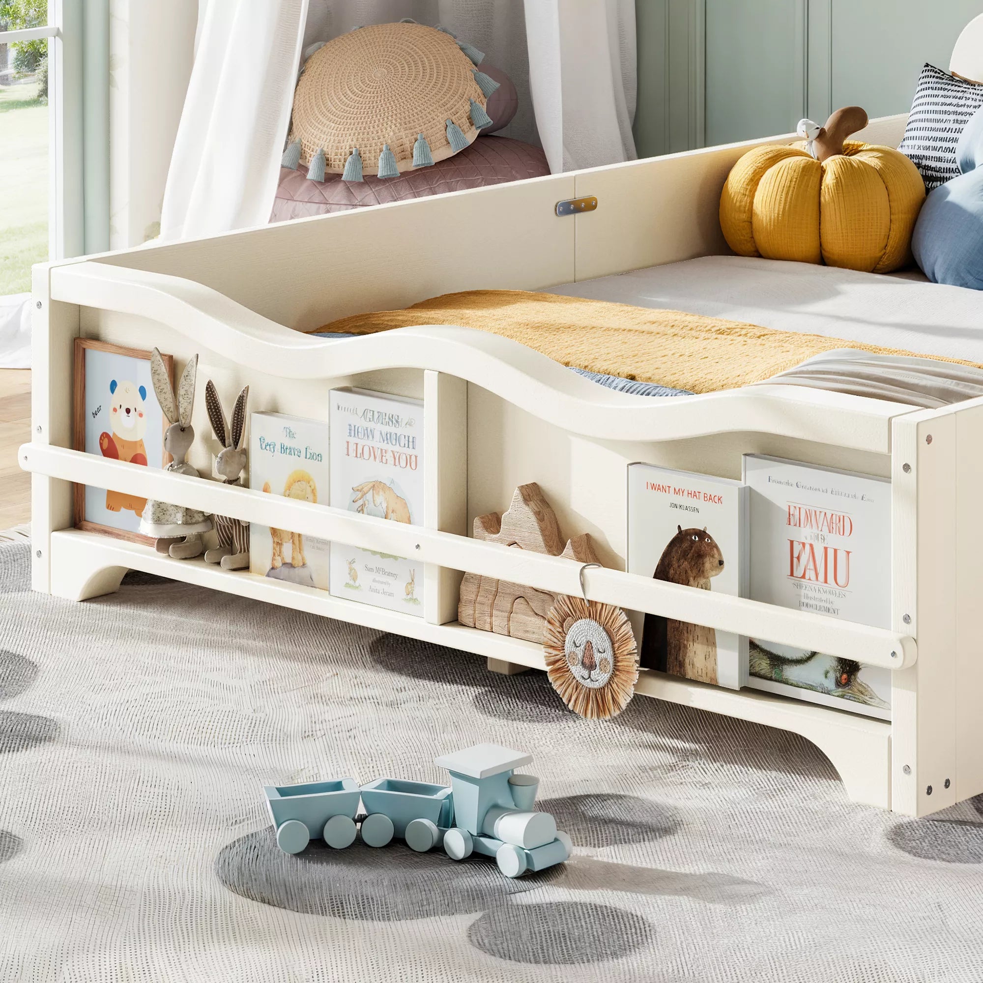 Close‑up of footboard book storage shelf on white kids bed, filled with children books and decor