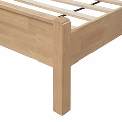 Close-up of the wooden bed leg and side rail connection