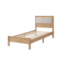 Angled view of the wooden bed frame with upholstered headboard and slat support base