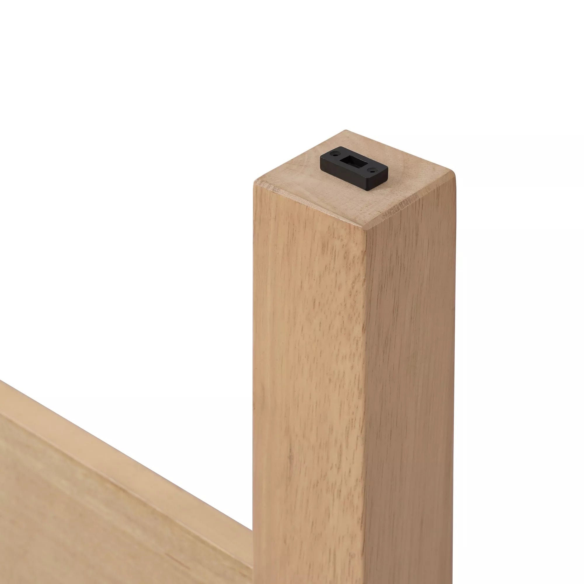 Close-up of a wooden bed leg with a black protective foot