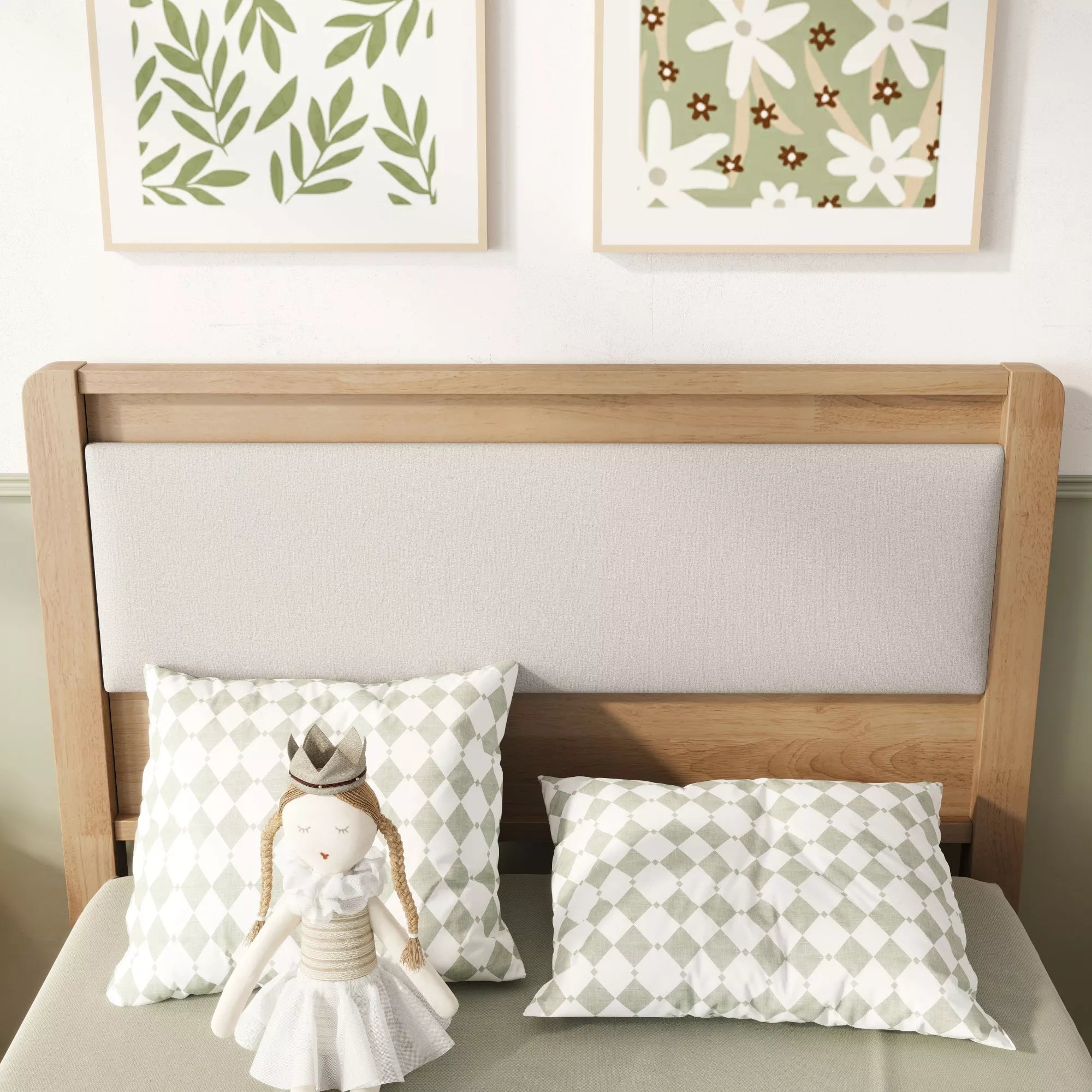 Close-up of the upholstered headboard and pillows on the wooden bed