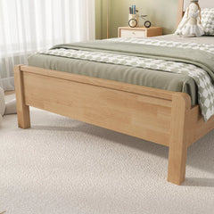Side-angle view of the natural wood bed frame showing the headboard, footboard, and slats