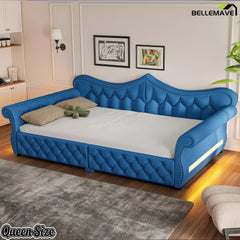 Blue upholstered queen daybed with diamond tufting and rolled arms
