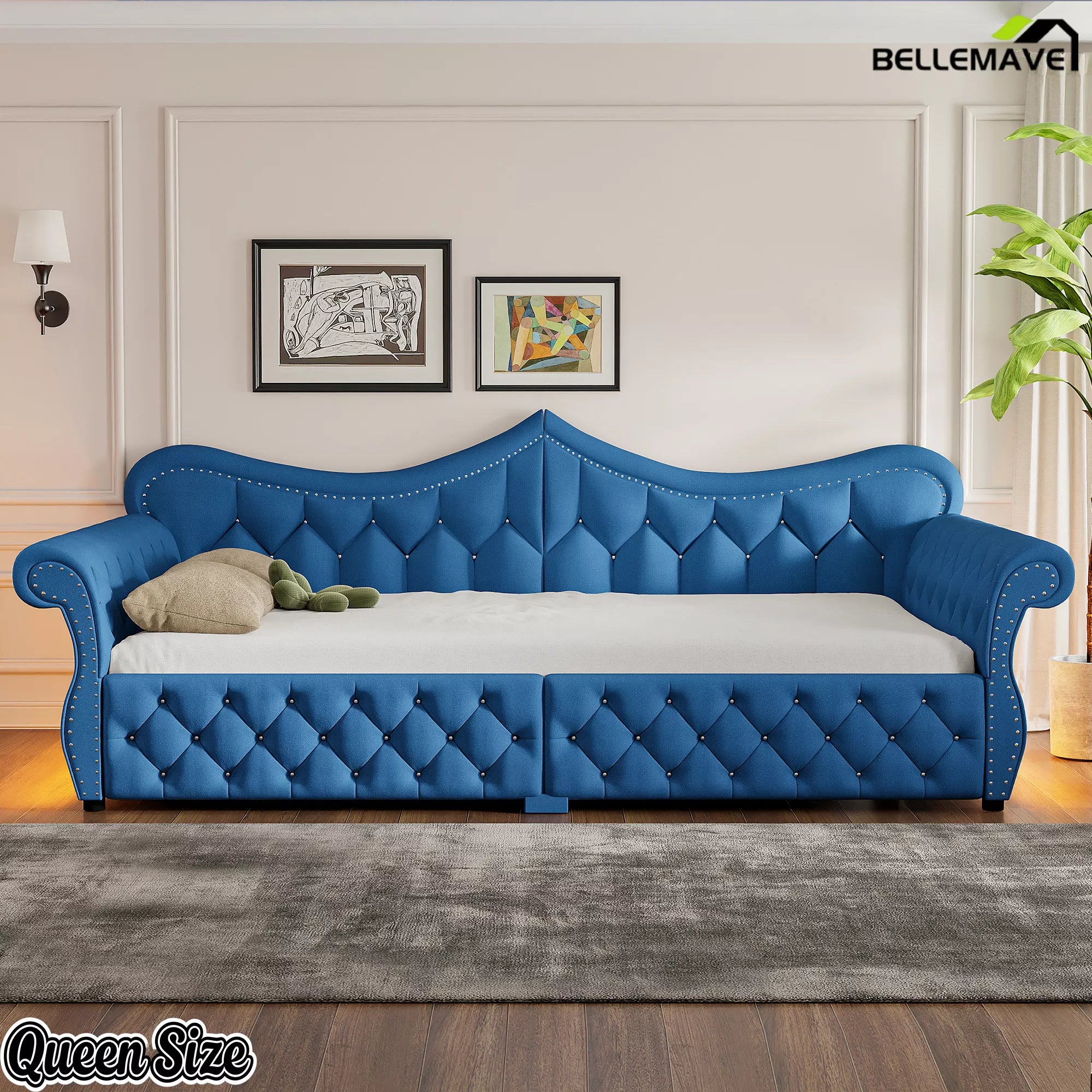 Blue upholstered daybed with tufted upholstery and rolled armrests