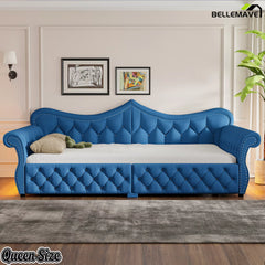 Blue upholstered daybed with tufted upholstery and rolled armrests
