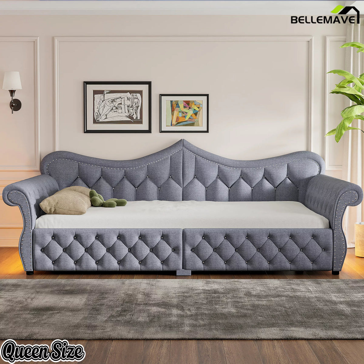 Front view of gray upholstered daybed with tufted backrest and nailhead trim