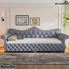 Front view of gray upholstered daybed with tufted backrest and nailhead trim