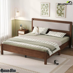 Dark wood Queen bed with upholstered headboard in a bedroom, angled view