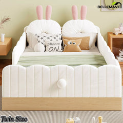 Front view of white twin upholstered bed with bunny pillows and wood-look base