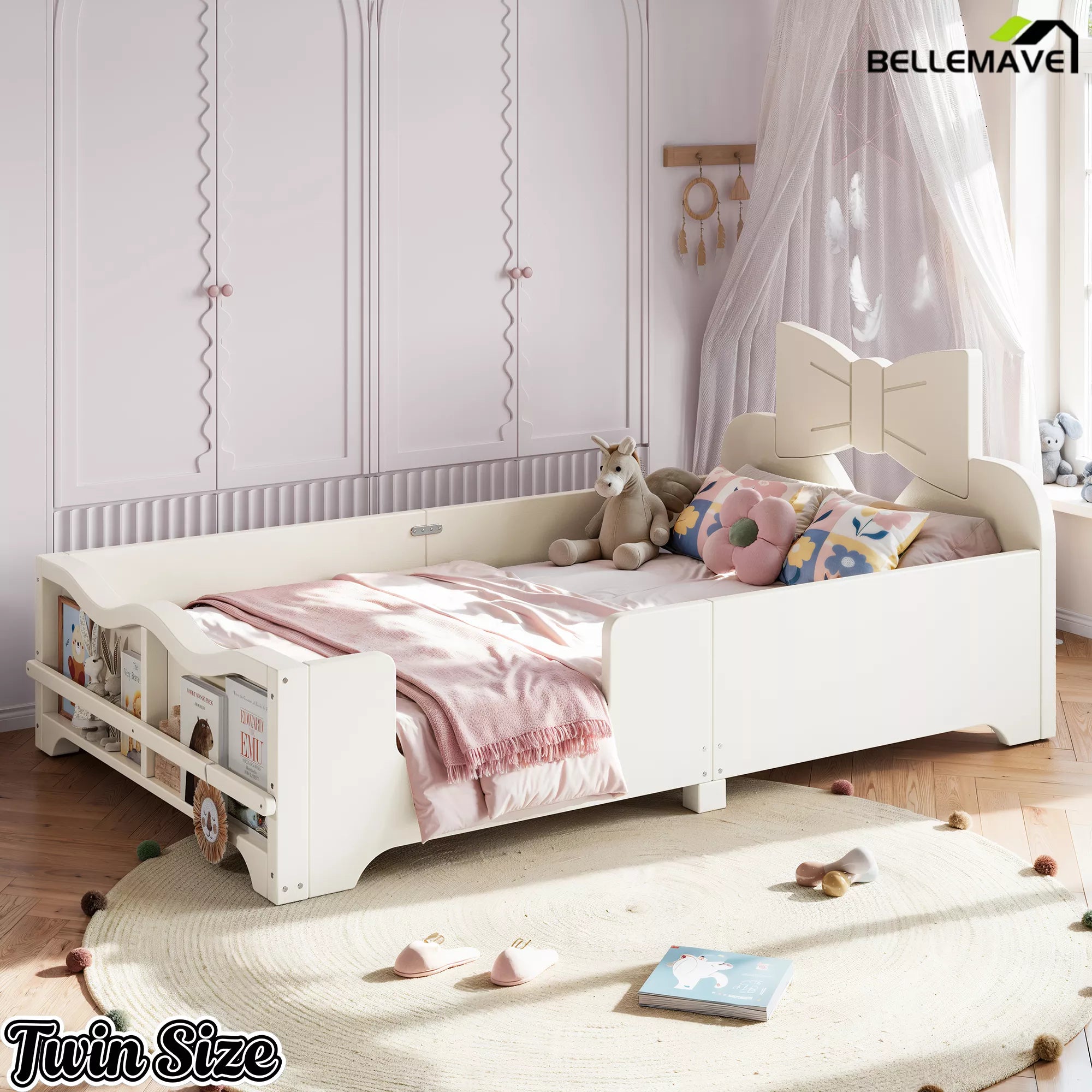 Oblique view white twin size children platform bed with bow headboard, safety side rails and footboard book shelf in kid’s bedroom