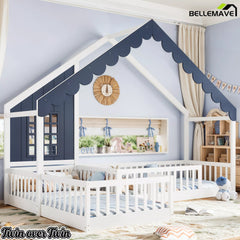 Angled view of a blue and white house-shaped floor bed with guardrails in a kids' bedroom