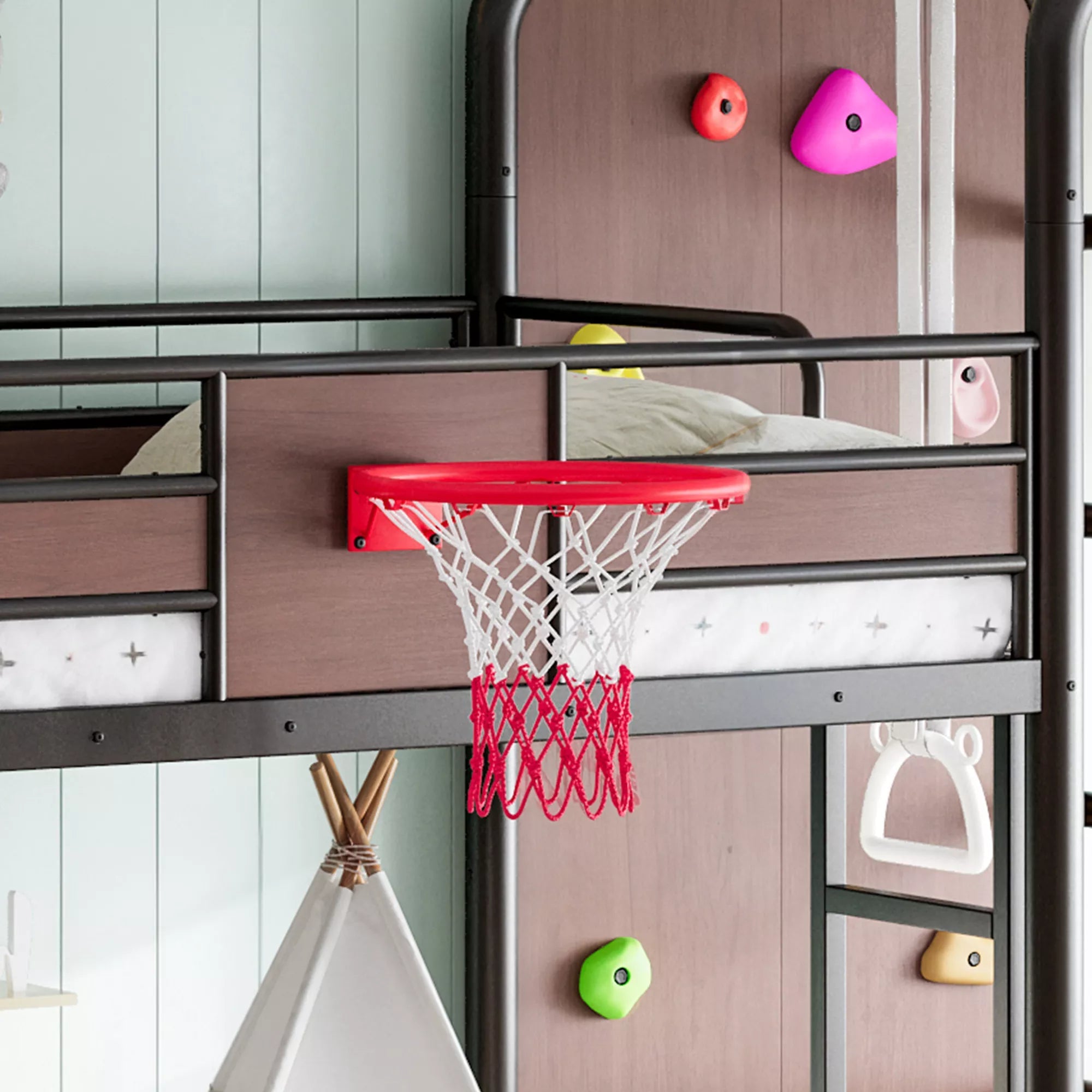 Close view of kids loft bed climbing wall, basketball hoop and pull-up rings