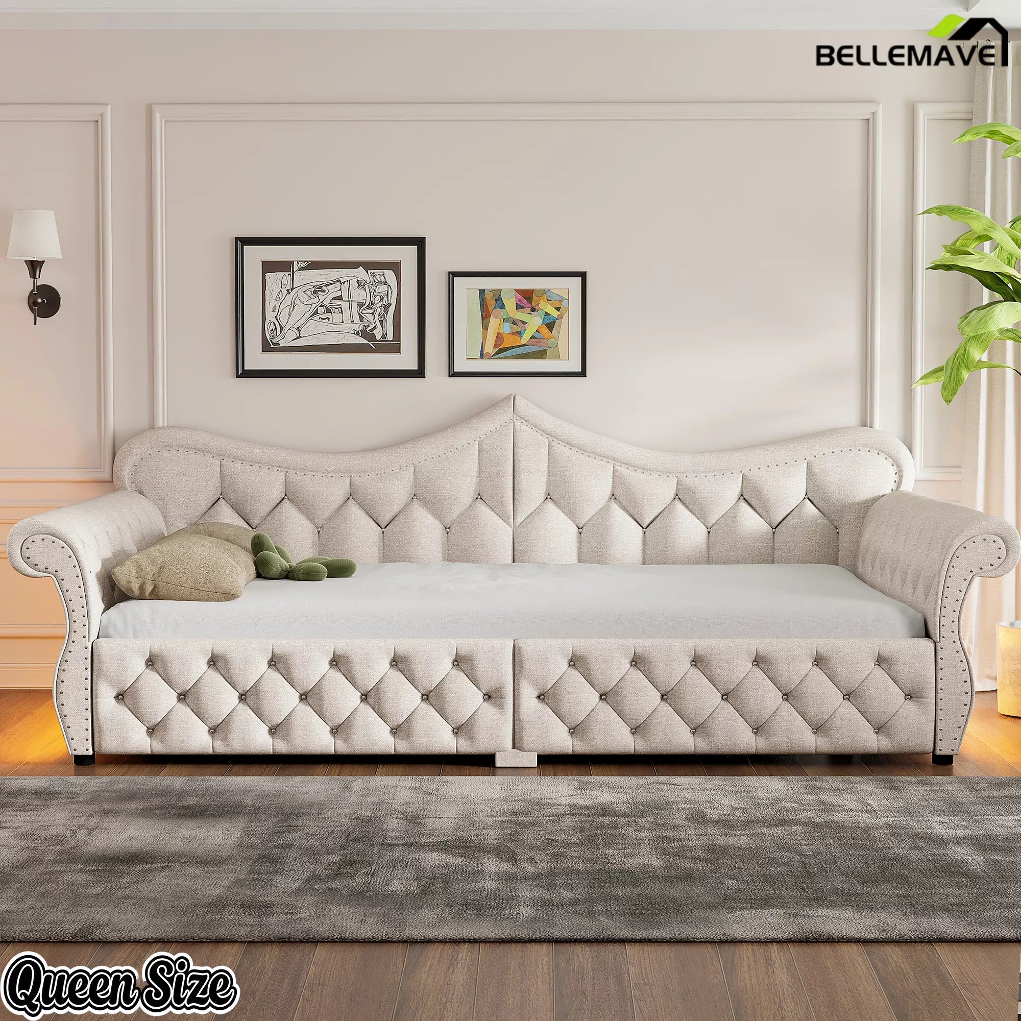 Cream upholstered queen daybed with diamond tufting and rolled arms in a bedroom