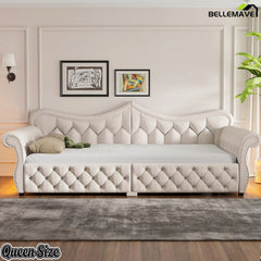 Cream upholstered queen daybed with diamond tufting and rolled arms in a bedroom