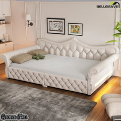 Cream upholstered daybed with tufted backrest and matching side arms