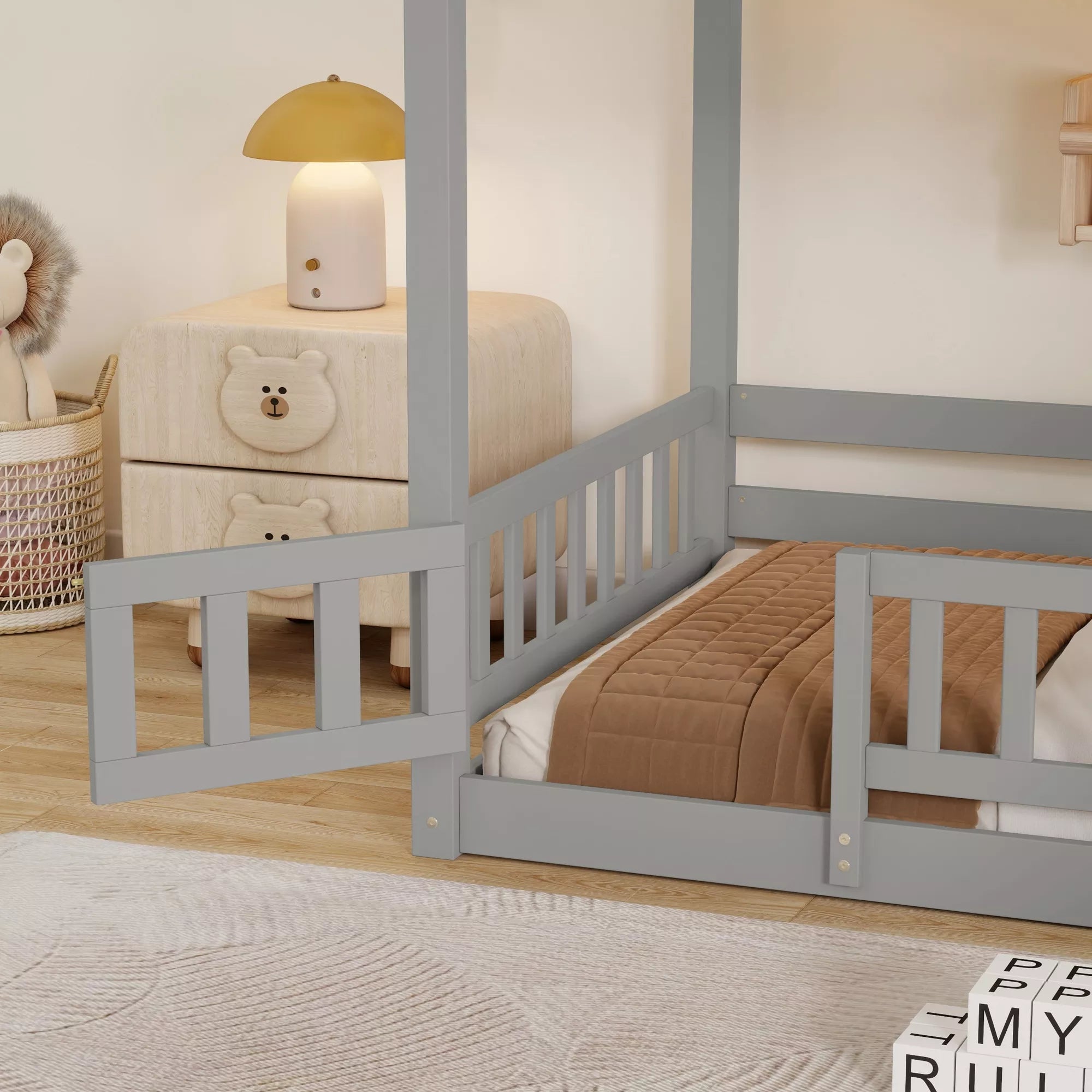 Close-up of gray bunk bed guardrails and lower bunk in a bedroom