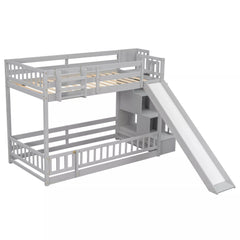Front angled view of gray twin over twin bunk bed with slide and storage staircase