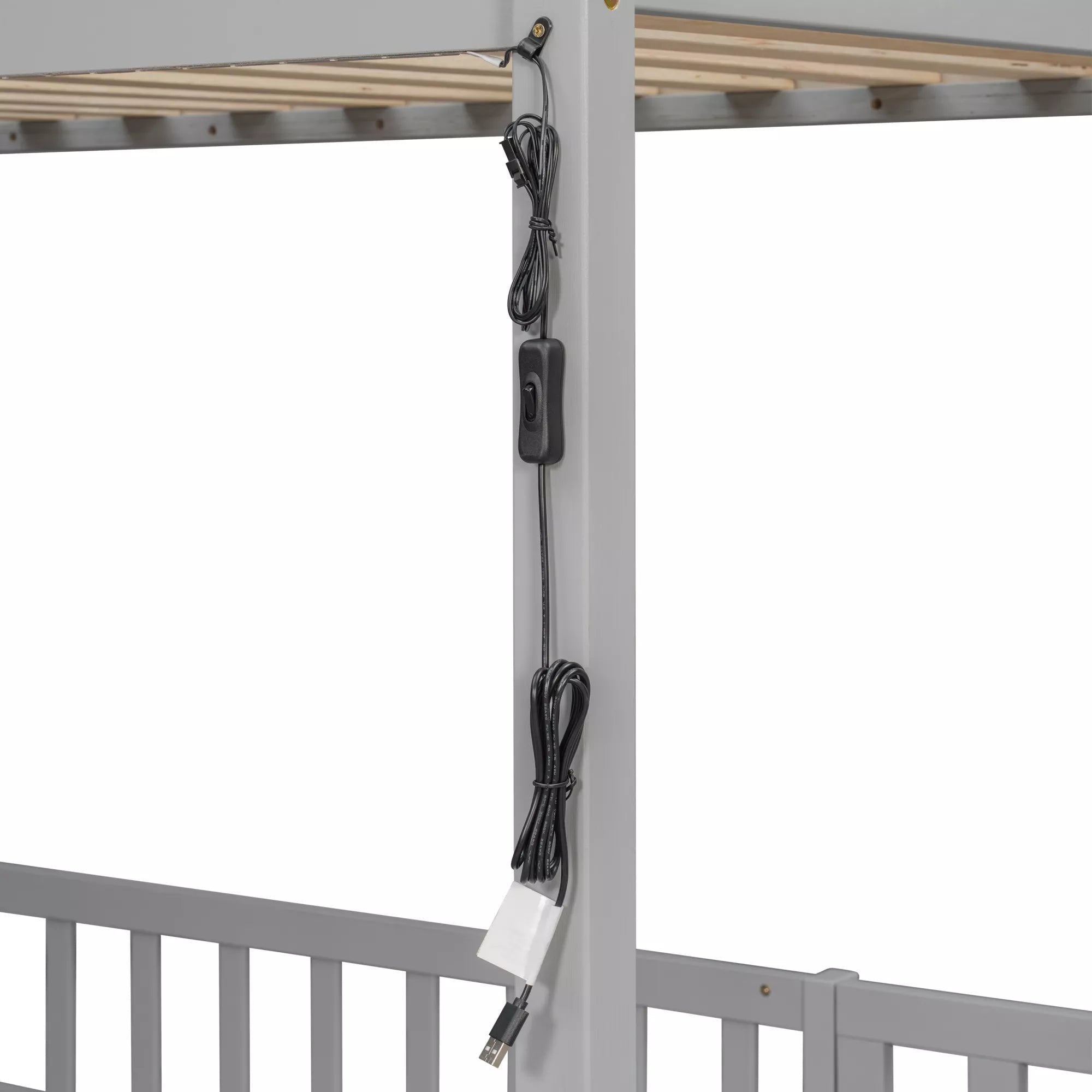 Close-up of wiring routed along the upper bunk frame of a gray twin over twin bunk bed