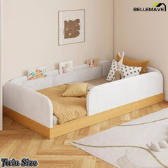 Angled bedroom view of white twin platform bed with upholstered guardrails