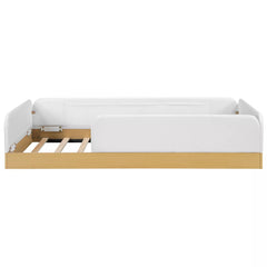 Twin upholstered platform bed with white guardrails and natural wood-look base