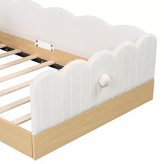 Close-up of scalloped upholstered footboard and wood-look bed base